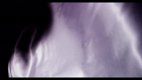 Rippling Purple and White Satin Fabric Close-up