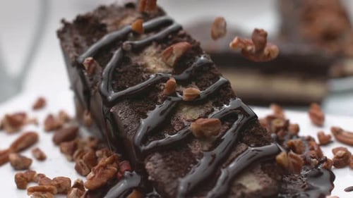 Chocolate Brownie Dessert with Pecans and Chocolate Sauce
