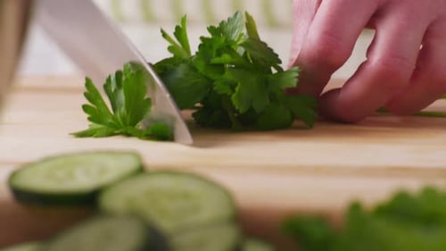 Chopping Fresh Parsley on Cutting Board Close Up