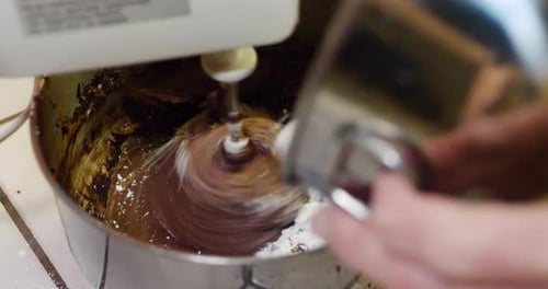 Electric Mixer Mixing Chocolate Batter Close Up