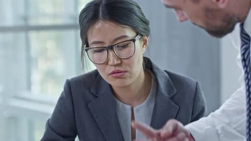 Professionals Reviewing Data in Office Setting