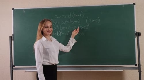 Smiling Woman Explaining Math Equations on Chalkboard