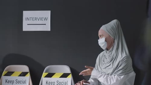 Woman Waiting in Masked Interview Waiting Room