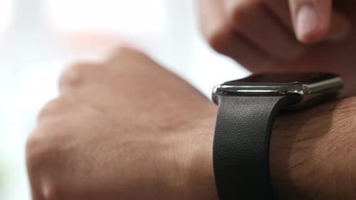 Person Interacting with a Smart Watch, Close-Up