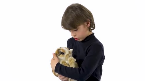 Child Holds and Cares for Brown and White Rabbit