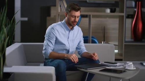 Businessman Finishing Conference Call Leaving Office Work in Remote Workplace