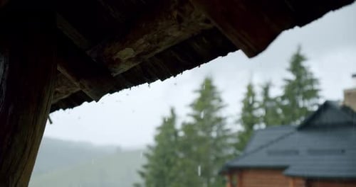 Rain Water Dropping From Brown Tile Roof in Day Time. Slow Motion