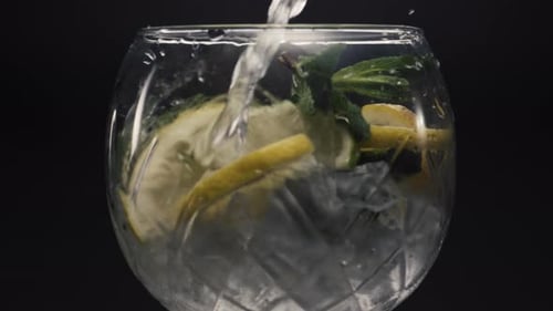 Water Being Poured into a Refreshing Lemon Drink