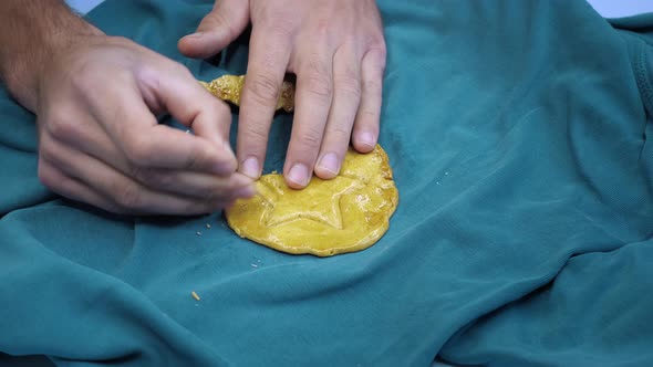 Cover for Squid game. Man hands scratch sugar caramel candy in shape of cookies