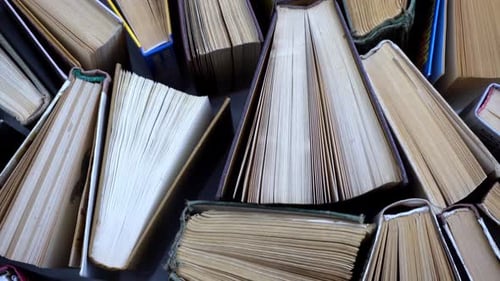 Books stacked and piled in a library setting