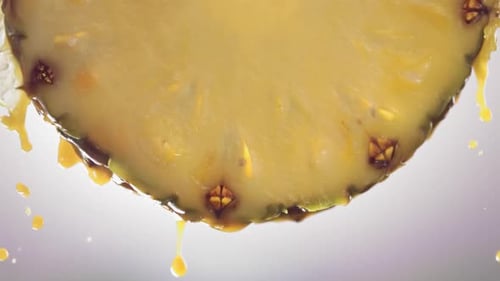 Flowing Pineapple Juice From Pineapple Slice Macro Shot in Slow Motion