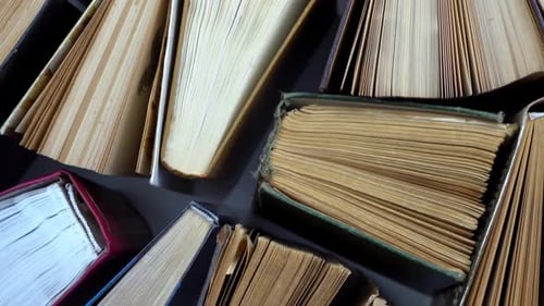 Overhead View of Stacked Classic Books with Yellowed Pages