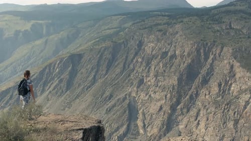 Girl Tourist Comes To the Edge of the Cliff Having Achieved Success Looking Forward