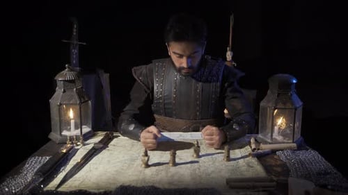 Man in Armor Planning Strategy by Candlelight