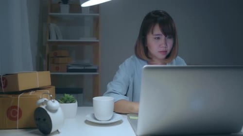 Woman Working at Desk at Night
