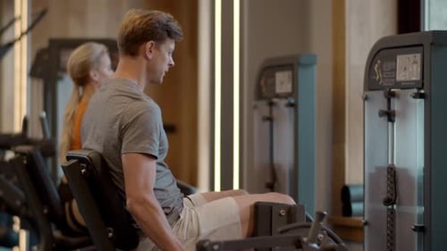 Serious Bodybuilder Workout at Gym. Fitness Man Making Leg Press in Sport Club