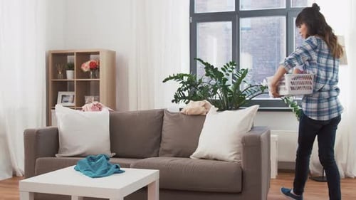 Asian Woman Picking Dirty Laundry at Home
