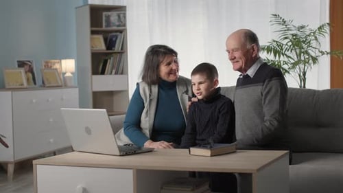 Grandparents and Grandson Using a Laptop Together