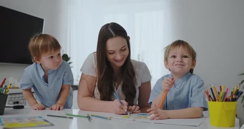 Mother Drawing with Her Children at Home
