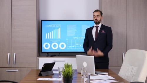 Businessman in Front of Big TV