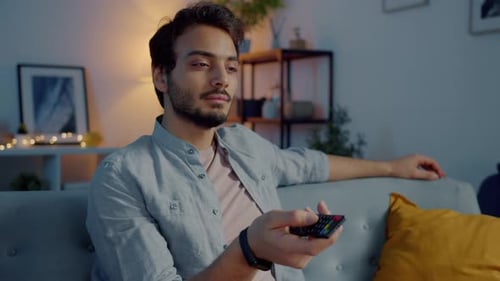 Man Watching Television on Couch in Living Room