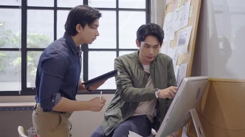 Creative Professionals Collaborating on Computer in Modern Office