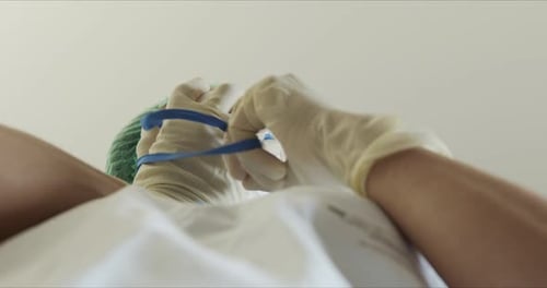 Doctor in Protective Suit Wearing Face Mask Low Angle View