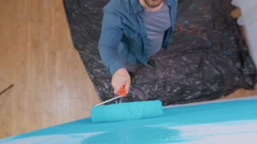 Ansicht eines Mannes, der die Wand malt