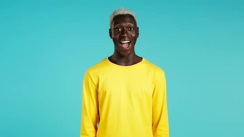 Young Adult's Happy Reaction on Blue Background