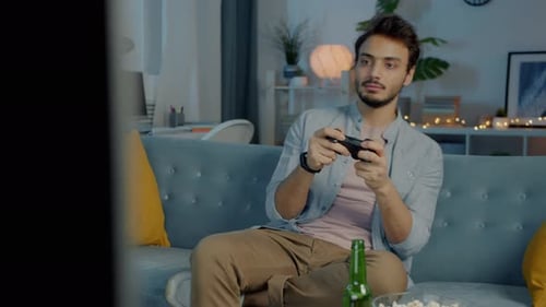 Man Plays Video Games At Home At Night