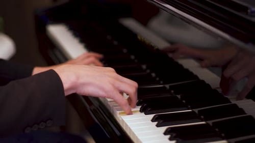Caucasian Young Man Plays Classical Composition on a Piano in a Luxury Hotel Restaurant.