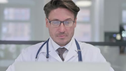Close Up of Doctor with Laptop Showing Thumbs Down