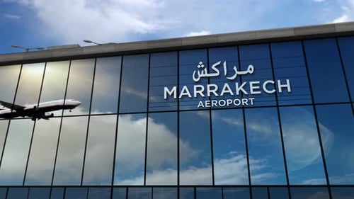 Airplane landing at Marrakesh, Marrakech Morocco airport mirrored in terminal