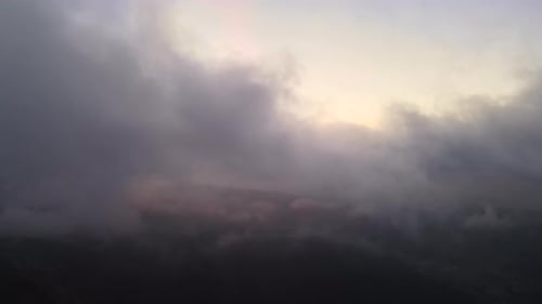 Aerial View of Bright Foggy Morning Over Dark Peak with Mountain Forest Trees at Autumn Sunrise