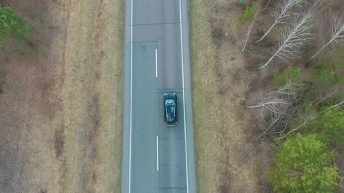 Aerial View Electric Car Driving on Country Road, Luxury Car Driving Through Mist at Dusk with