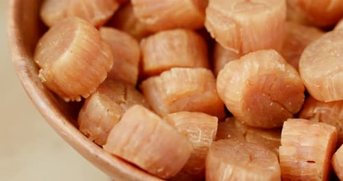Close-Up of Dried Scallops in Wooden Bowl
