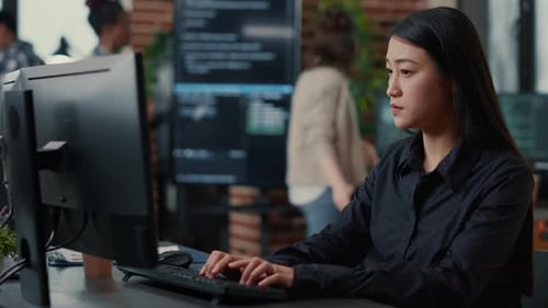 Programer Writing Algorithm Focused on Compiling Source Code Sitting at Desk