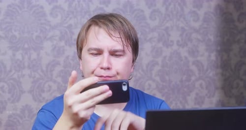 Adult Reacting to Phone Screen with Surprise
