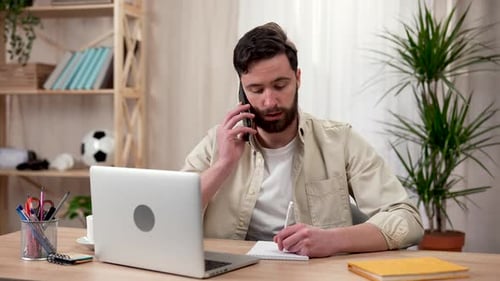 Man on Phone Call Working at Home Office