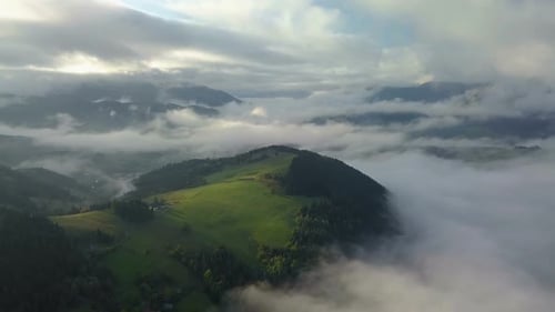Breathtaking Aerial View of Rolling Green Hills and Clouds