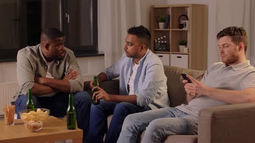 Three Friends Relaxing Indoors with Beer and Conversation