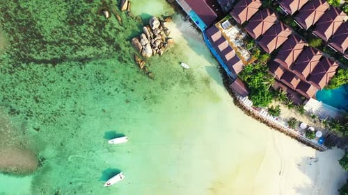 Luxury aerial tourism shot of a sunshine white sandy paradise beach and aqua blue ocean background