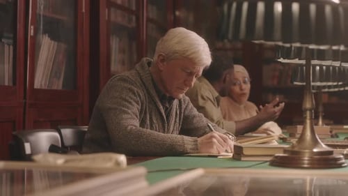 University Professor Working in Library