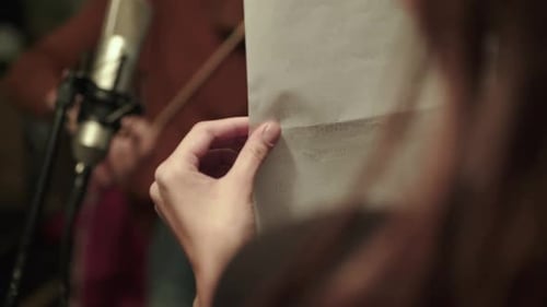Focused Young Adult Playing Violin in Home Studio
