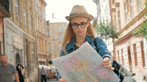 Woman Tourist Navigating City Streets with Map