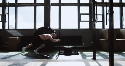 Side Dolly Shot Young Strong Caucasian Athletic Sportsman Exercising with Heavy Training Sled in