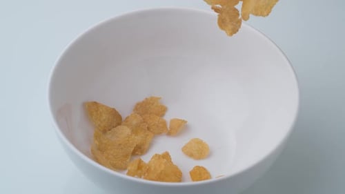 Pouring Golden Cornflakes Into a Bowl