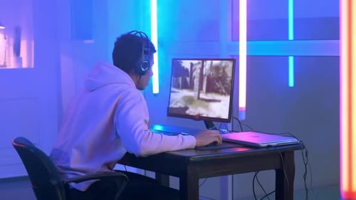 Young Adult Gamer Concentrating on Video Game