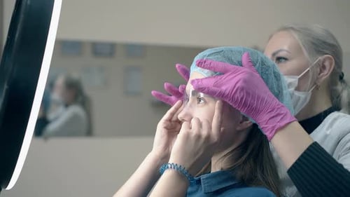 Makeup Artist Prepares Client for Beauty Procedure