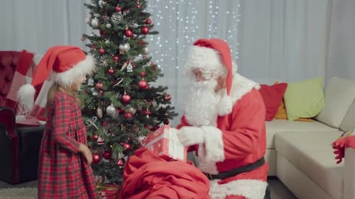 Girl Receives Christmas Gift from Santa Claus